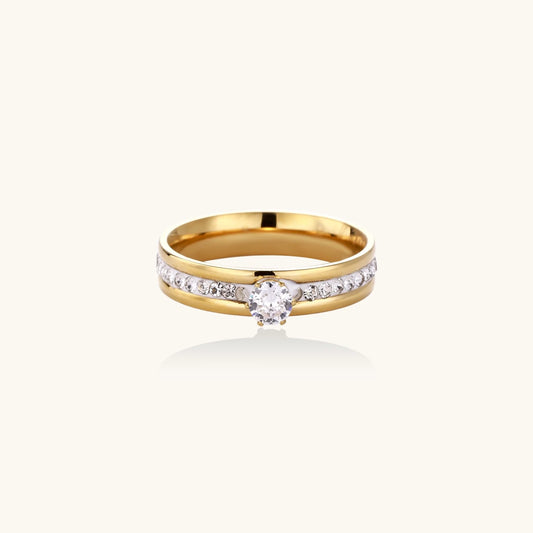 Gold-plated double-band ring with center rhinestone solitaire and channel-set stones on white background